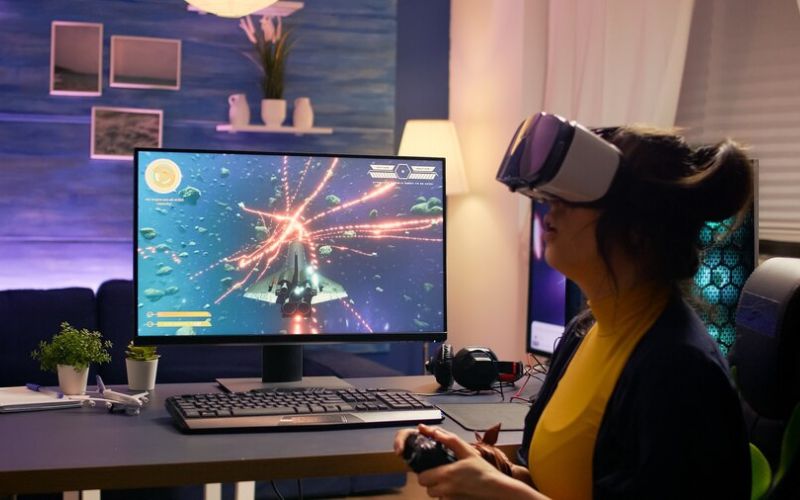 A woman immersed in virtual reality, wearing a VR headset, engrossed in playing a video game